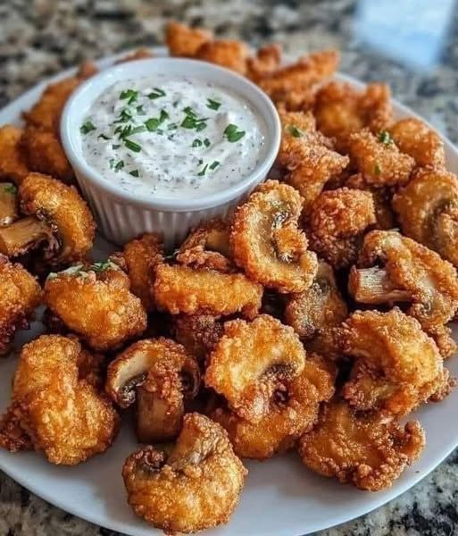 Deze krokante champignons met frisse ranchdip wil je deze zomer op tafel zetten
